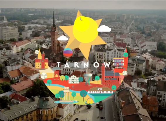 Kolorowe logo "Tarnów Hot Spot" na tle miasta nakręconego z lotu ptaka. Logo jest wzorowane na herbie miasta – leliwie. Leliwa to księżyc pod sześcioramienną gwiazdą. Gwiazdą z herbu jest słońce a księżycem - charakterystyczne budynki i zieleń Tarnowa.